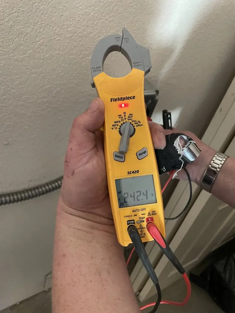 Voltage testing with clamp meter during Electrical Installation Services in West Chicago